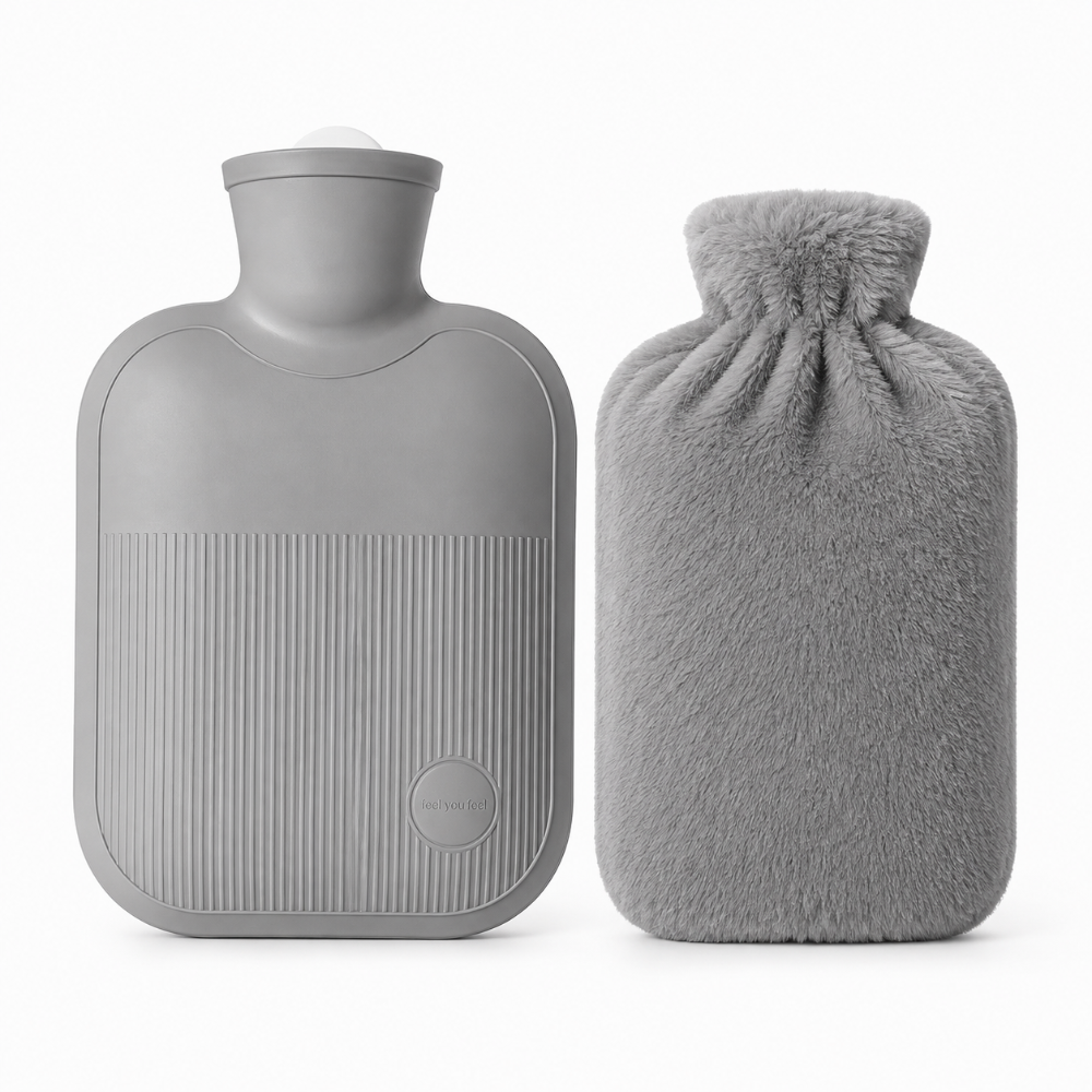 A gray hot water bottle with a ribbed textured front and a screw-top neck, shown next to a matching gray plush drawstring hot water bag on a clean white background.
